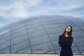 Brunetter girl next to a modern building Royalty Free Stock Photo