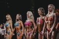Brunettes and blondes athletes fitness bikinis show off their flat tummies Royalty Free Stock Photo