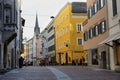 View of Brunico village promenade with its coloful houses and shops in the historic center of Brunico, Alto Adige, Italy