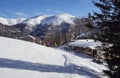 Brunnach Ski Resort, St. Oswald, Carinthia, Austria - January 20, 2019: A cabin next to the ski slope with skiers in front,