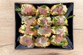 Savory bruschetta with egg paste, arugula, and smoked ham Royalty Free Stock Photo