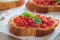 Bruschetta bread with chopped tomato and basil on paper Royalty Free Stock Photo