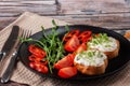 Bruschetta with cheese, salmon and micro-greens on a dish