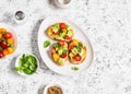 Bruschetta with cherry tomatoes, avocado and basil. On a light background. Royalty Free Stock Photo