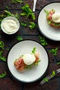 Bruschetta with cream cheese, wilde rucola, parma ham and poached egg served on white plate. Royalty Free Stock Photo