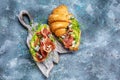 Bruschetta Croissant with italian prosciutto or spanish jamon. Delicious breakfast or snack on a blue background, top view Royalty Free Stock Photo