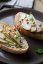 Bruschetta with curd cheese, pear and pine nuts