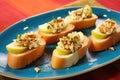 bruschetta featuring apple slices and gorgonzola sprinkles against a yellow cloth background