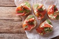 Bruschetta with figs, prosciutto, arugula and cream cheese close