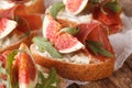 Bruschetta with figs, prosciutto, arugula and cream cheese macro