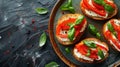 Bruschetta with fresh ricotta cheese and cherry tomatoes on wooden board decorated with basil leaves. Closeup view Royalty Free Stock Photo