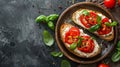 Bruschetta with fresh ricotta cheese and cherry tomatoes on wooden board decorated with basil leaves. Closeup view Royalty Free Stock Photo