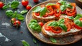 Bruschetta with fresh ricotta cheese and cherry tomatoes on wooden board decorated with basil leaves. Closeup view Royalty Free Stock Photo