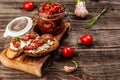 Bruschetta with goat cheese, sun-dried tomatoes on a light table, top view Food recipe background. Close up Royalty Free Stock Photo