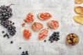 Bruschetta, ham, olives, grapes and nuts Royalty Free Stock Photo