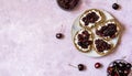 Wholewheat toasts with ricotta and homemade sweet cherry jam on plate. top view. Copy space