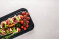 Bruschetta with meat, olives, herbs and parmesan cheese on bread. Cold snacks. Italian cuisine. Royalty Free Stock Photo