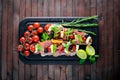 Bruschetta with meat, olives, herbs and parmesan cheese on bread. Cold snacks. Italian cuisine. Royalty Free Stock Photo