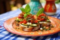 bruschetta offering with spiced courgette ribbons on a polka-dotted plate