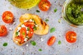 Bruschetta with pesto sauce, feta cheese, tomatoes and basil Royalty Free Stock Photo