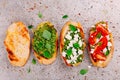 Bruschetta with pesto sauce, feta cheese, tomatoes and basil Royalty Free Stock Photo