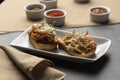 Bruschetta on plate and leather mat with spices on background Royalty Free Stock Photo