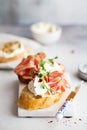 Bruschetta with prosciutto and cream cheese. Bread with smoked bacon and cream cheese. Toasted bread slice with meat and cream Royalty Free Stock Photo