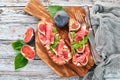 Bruschetta with prosciutto, fresh figs and cheese. Royalty Free Stock Photo