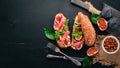 Bruschetta with prosciutto, fresh figs and cheese. On the old background. Healthy food. Free space for text. Royalty Free Stock Photo