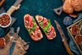 Bruschetta with prosciutto, fresh figs and cheese. On the old background. Healthy food. Free space for text. Royalty Free Stock Photo