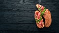 Bruschetta with prosciutto, fresh figs and cheese. On the old background. Healthy food. Free space for text. Royalty Free Stock Photo