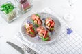 Bruschetta with rye bread, prosciutto, cream cheese, capers and salad leaves