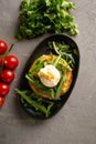 Bruschetta salmon with avocado - salted salmon with guacamole, arugula and poached egg on a warm fried bun