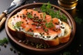 Bruschetta with salmon. Breakfast toast with cream cheese, salmon, capers and greens on a plate, macro close-up. Keto