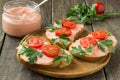 Bruschetta with salmon butter, capelin caviar, cherry tomatoes a Royalty Free Stock Photo