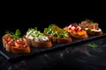 Bruschetta with salmon, cream cheese and parsley on black background