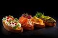 Bruschetta with salmon, cream cheese and vegetables on black background