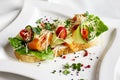 Bruschetta with salmon red fish, fresh vegetables and herbs Royalty Free Stock Photo