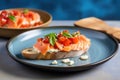 bruschetta with salmon slice on a light blue dish