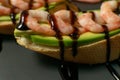 bruschetta with shrimps, avocado and lime on a plate