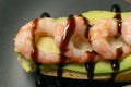 bruschetta with shrimps, avocado and lime on a plate