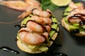 bruschetta with shrimps, avocado and lime on a plate