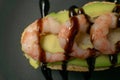 bruschetta with shrimps, avocado and lime on a plate