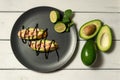 bruschetta with shrimps, avocado and lime on a white wooden background Royalty Free Stock Photo