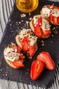 Bruschetta with strawberries, blue cheese, walnut and honey on stoyn plate