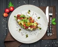 Bruschetta with sun-dried tomatoes, cream cheese, avocado and fresh vegetables Royalty Free Stock Photo