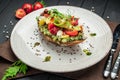 Bruschetta with sun-dried tomatoes, cream cheese, avocado and fresh vegetables Royalty Free Stock Photo
