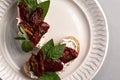 Bruschetta with sun-dried tomatoes, cream cheese and fresh vegetables. Healthy and wholesome food. Serving food in a Royalty Free Stock Photo