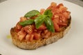 Bruschetta (toasted bread) with tomato and basil in closeup. Royalty Free Stock Photo