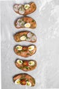 Bruschetta with tomato, avocado and quail egg snacks, vertical Royalty Free Stock Photo